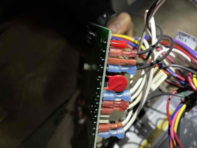 Conducted comprehensive electrical diagnostics on system using Fieldpiece SC660 multimeter. Measured line voltage reading 255V and inspected control board connections. Identified and verified proper wiring terminations at the circuit board, ensuring all connector leads (red, blue, yellow, white) were secure and properly seated.