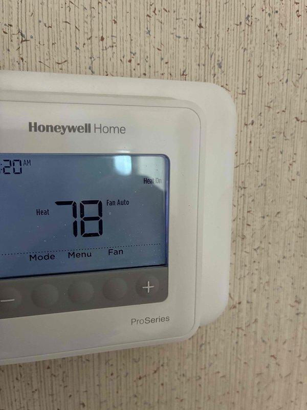 Performed maintenance service on HVAC system. Inspected Honeywell Home ProSeries thermostat (functioning properly with heat set to 78°F) and replaced severely clogged air filter which was completely saturated with dust and debris, restricting proper airflow to the furnace.