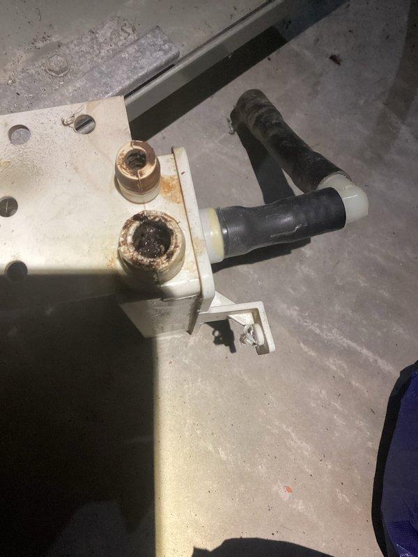 Responded to no heat call for system under 10 years old. Discovered condensate drain assembly with significant corrosion and mineral buildup causing blockage. Replaced damaged condensate trap and cleared drain line, restoring proper system operation and heat function.