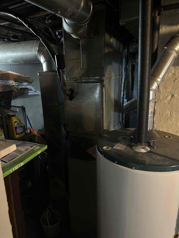 Conducted comprehensive inspection of electrical circuit breaker panel and HVAC system in basement utility area. Evaluated existing furnace/air handler unit with associated ductwork and water heater installation for replacement estimate. Documented current system configuration and electrical service capacity to determine appropriate replacement options.