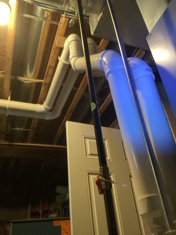 Conducted visual inspection of basement utility area containing furnace system. Examined exposed PVC vent piping and drainage components for proper installation and function. No active issues were identified with the heating system during this routine service call.