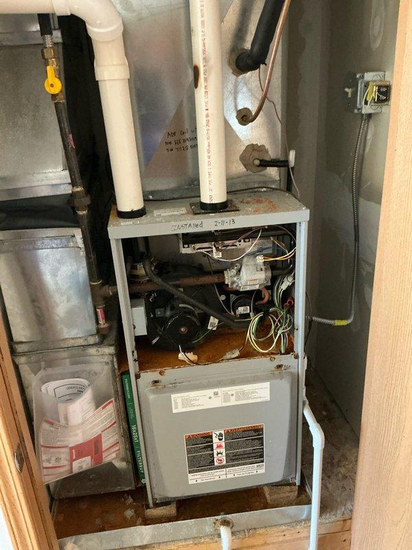 Performed inspection and estimate for replacement of aging Concord furnace system. Current unit shows signs of corrosion on floor beneath unit, suggesting possible water damage or leakage issues. Recommended full replacement of furnace system including upgrading PVC exhaust/intake ventilation components and ensuring proper gas line connection with appropriate safety valve installation.