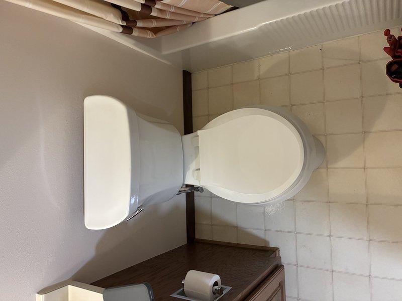 Installed new garbage disposal unit beneath sink, connecting all PVC drain pipes with proper fittings and securing connections with metal clamps. Verified system operation and confirmed no leaks at connection points after installation.