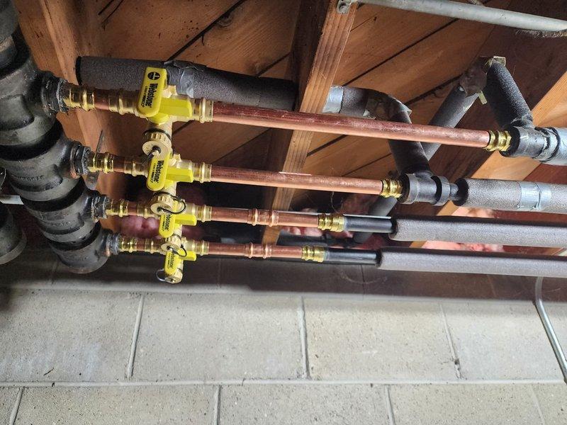 Completed commercial boiler installation with comprehensive copper gas line infrastructure. Installed multiple parallel gas lines with dedicated shut-off valves, properly secured to wooden joists with insulated brackets. All piping was properly insulated with foam sleeves where required and systematically labeled for future service identification.