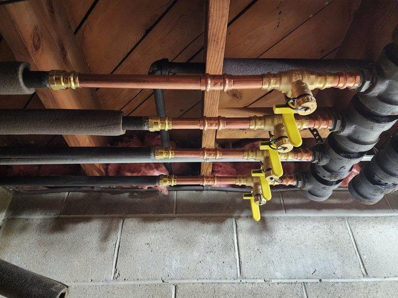 Completed commercial boiler installation with comprehensive copper gas line infrastructure. Installed multiple parallel gas lines with dedicated shut-off valves, properly secured to wooden joists with insulated brackets. All piping was properly insulated with foam sleeves where required and systematically labeled for future service identification.