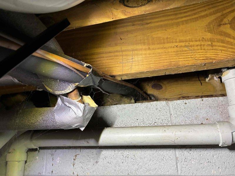 Conducted inspection of existing Lennox Pulse furnace in basement mechanical room for replacement estimate. Unit shows signs of age with potential issues in exhaust/intake piping. Evaluated surrounding ductwork, PVC connections, and crawl space access for new installation requirements.