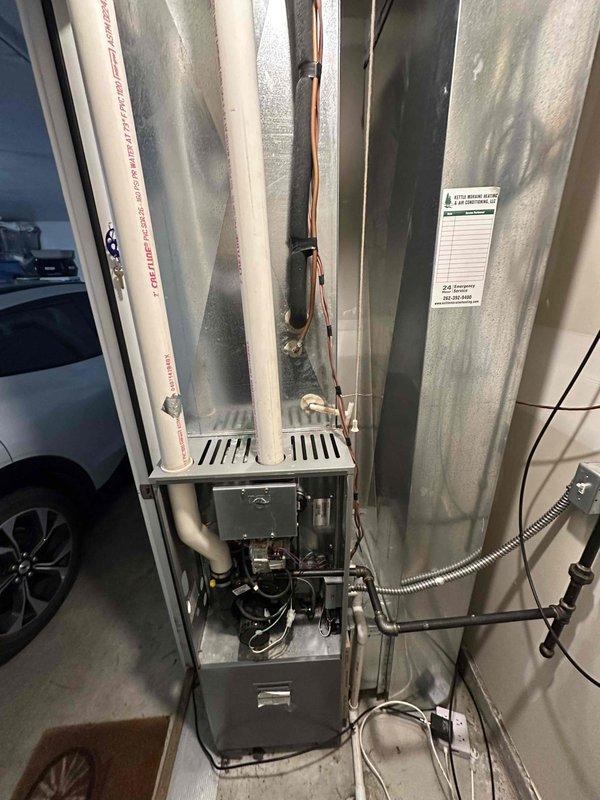 Conducted inspection of existing furnace system, documenting interior components including PVC ventilation pipes, copper line connections, and electrical wiring. Evaluated electrical service panel to assess capacity and compatibility for replacement unit, noting circuit breaker configuration and load distribution.