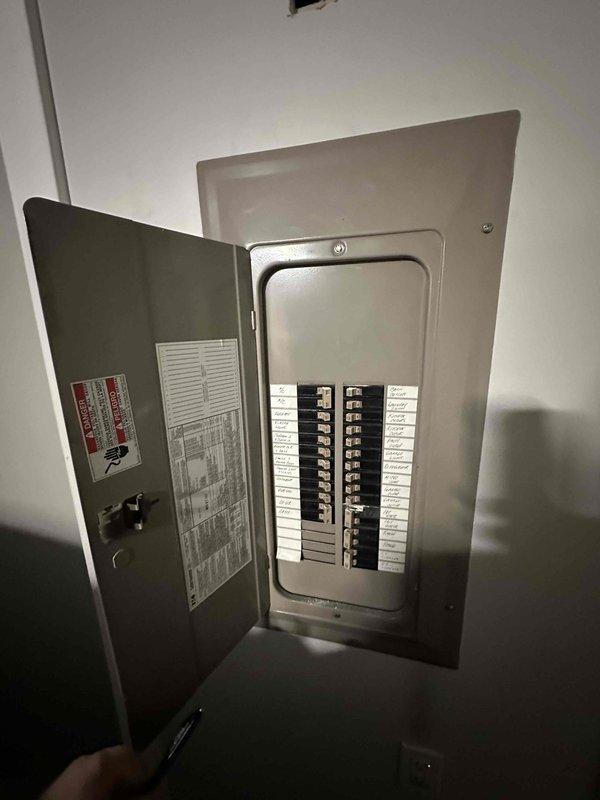 Conducted inspection of existing furnace system, documenting interior components including PVC ventilation pipes, copper line connections, and electrical wiring. Evaluated electrical service panel to assess capacity and compatibility for replacement unit, noting circuit breaker configuration and load distribution.