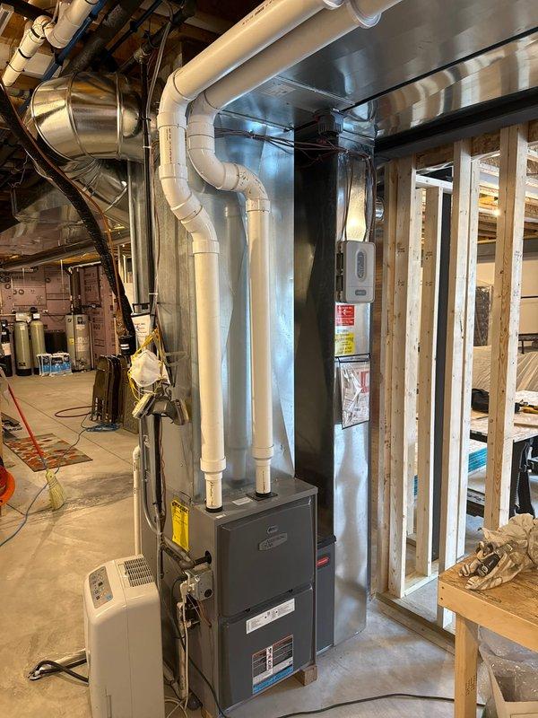 Completed installation of a comprehensive HVAC ductwork system, including the mounting of galvanized metal ducts with proper securing brackets throughout the structure. Installed and connected central furnace unit with PVC exhaust venting, ensuring proper integration with the newly installed duct network in the mechanical room.