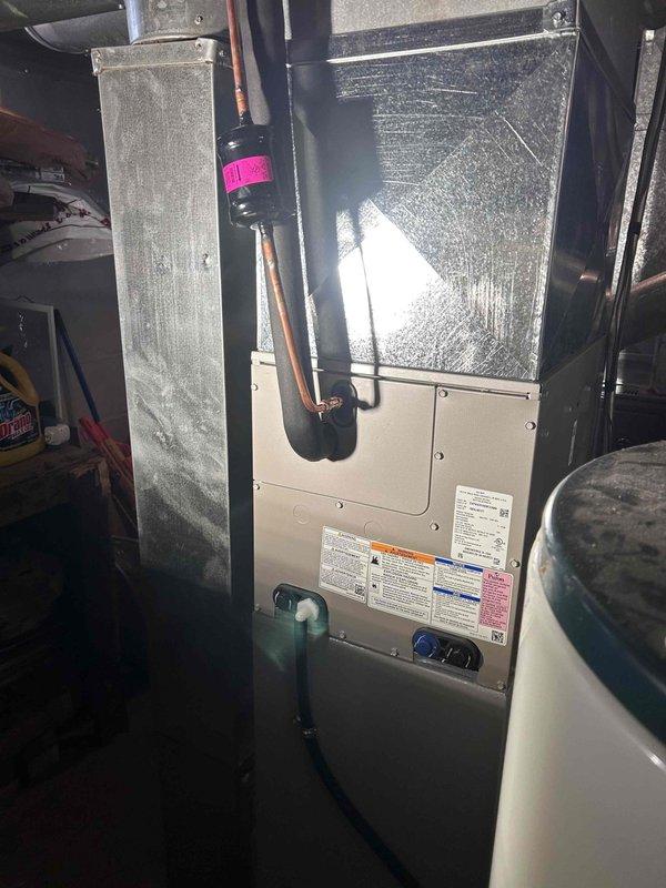 Completed installation of new A/C unit with matching evaporator coil, including proper connection of refrigerant lines with appropriate fittings and filter drier. System was properly secured to existing ductwork in utility area, with condensate drain line installed for proper moisture removal.