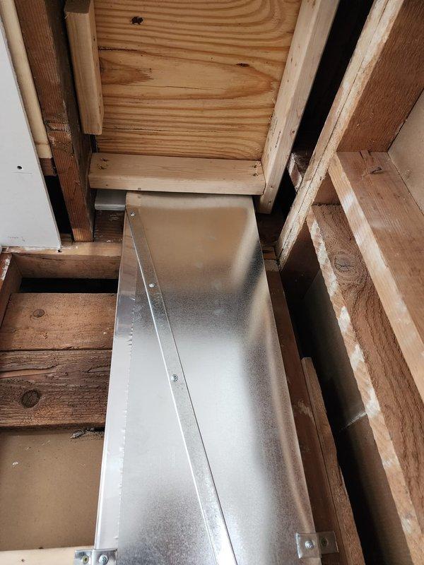 Successfully installed new galvanized sheet metal ductwork in basement utility area, including horizontal main trunk line with vertical branch connection. System was properly secured to wooden joists and framing members, with all connections sealed and fastened according to specifications.