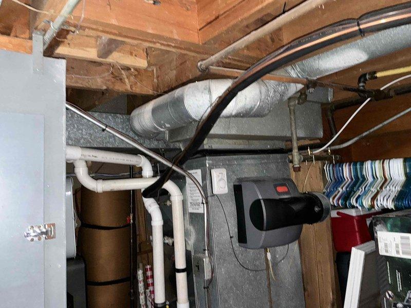 Conducted comprehensive assessment of existing HVAC system located in residential basement. Documented aging furnace with attached humidifier, examining structural integrity of metal ductwork, PVC ventilation components, and electrical connections. Recommended complete system replacement due to observed efficiency loss and potential end-of-life issues.