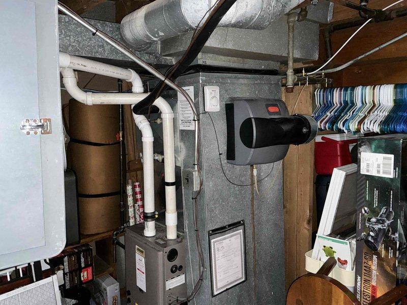 Conducted comprehensive assessment of existing HVAC system located in residential basement. Documented aging furnace with attached humidifier, examining structural integrity of metal ductwork, PVC ventilation components, and electrical connections. Recommended complete system replacement due to observed efficiency loss and potential end-of-life issues.