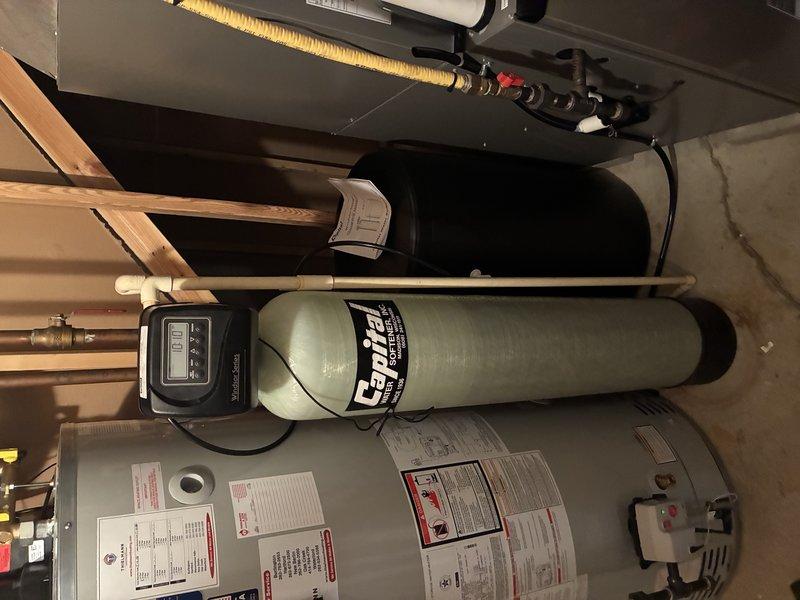 Completed installation of new water service system in residential utility area, including connection of water softener ("Calice" model with digital control panel) and integration with existing water heater. System was properly plumbed with all necessary pipes, fittings, and valves to ensure optimal functionality of the home's water distribution system.