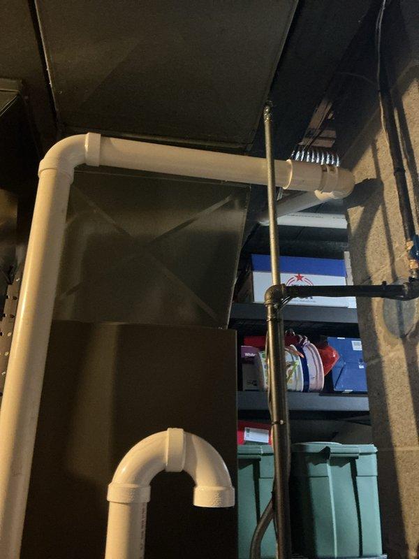 Performed routine maintenance on Lennox furnace system located in utility room. Inspected PVC venting pipes, drain lines, and connection to ductwork, confirming proper installation and function. Visual examination revealed system to be in good working condition with no immediate concerns.