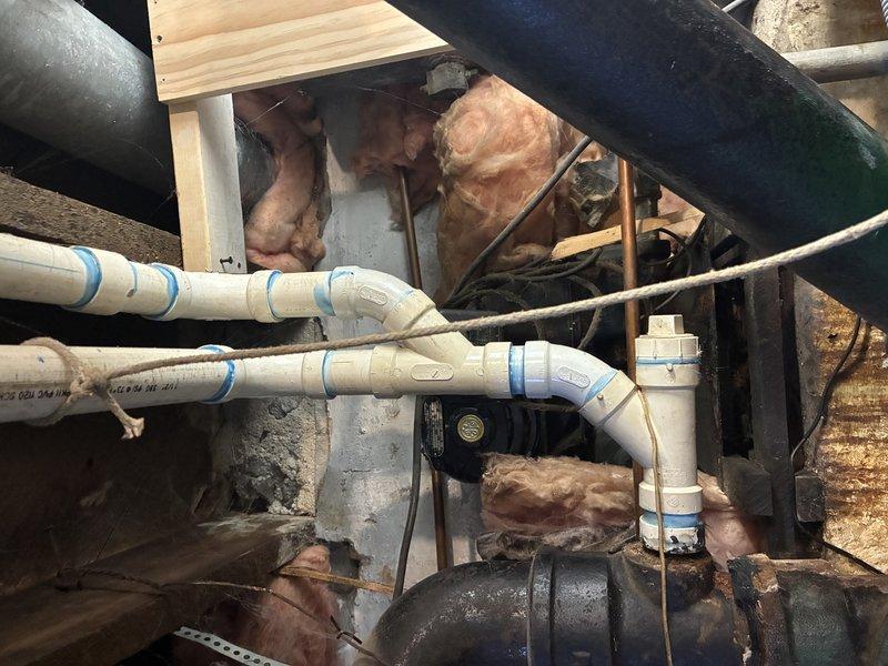 Completed main line repair in basement area involving replacement of deteriorated cast iron pipe sections with new PVC piping. Installed multiple connection points and bends in the horizontal run, properly securing new piping to existing structure with appropriate supports. Applied insulation around vulnerable sections to prevent condensation and protect against temperature fluctuations.