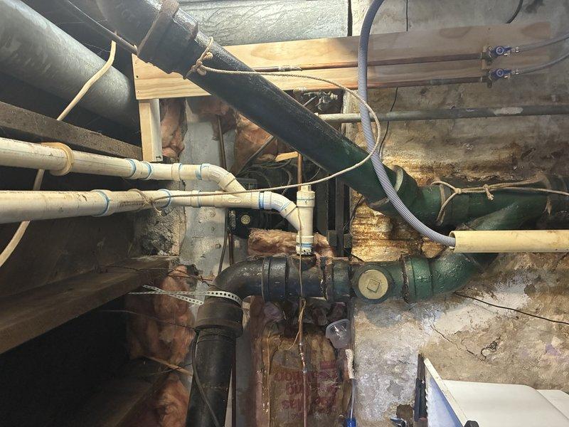 Completed main line repair in basement area involving replacement of deteriorated cast iron pipe sections with new PVC piping. Installed multiple connection points and bends in the horizontal run, properly securing new piping to existing structure with appropriate supports. Applied insulation around vulnerable sections to prevent condensation and protect against temperature fluctuations.