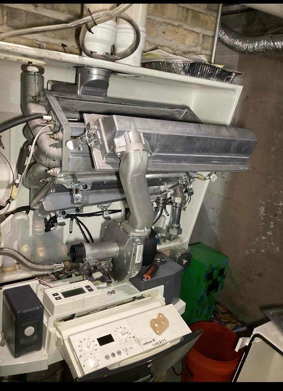 Performed diagnostic inspection of wall-mounted boiler system in utility room, examining heat exchangers, electrical connections, and control panel functionality. Checked all plumbing connections, including copper supply lines and PVC drainage pipes, ensuring proper installation and operation of the heating system. Verified proper venting through flexible metallic ductwork and confirmed system was operating within manufacturer specifications.