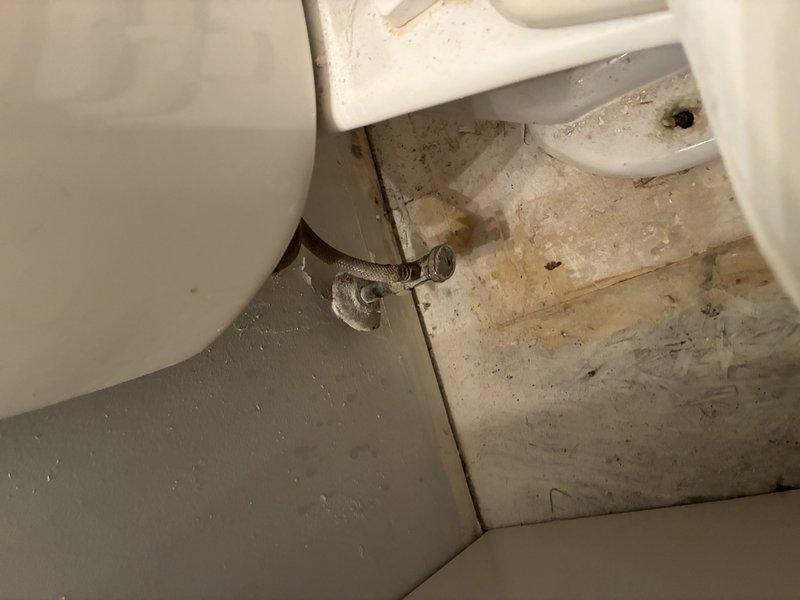 Conducted comprehensive toilet inspection revealing significant issues: toilet base shows poor sealing with accumulated grime and possible water damage to surrounding flooring, while tank inspection revealed an aging flush mechanism with extensive corrosion, mineral buildup, and potential porcelain crazing that may affect proper function and water efficiency.