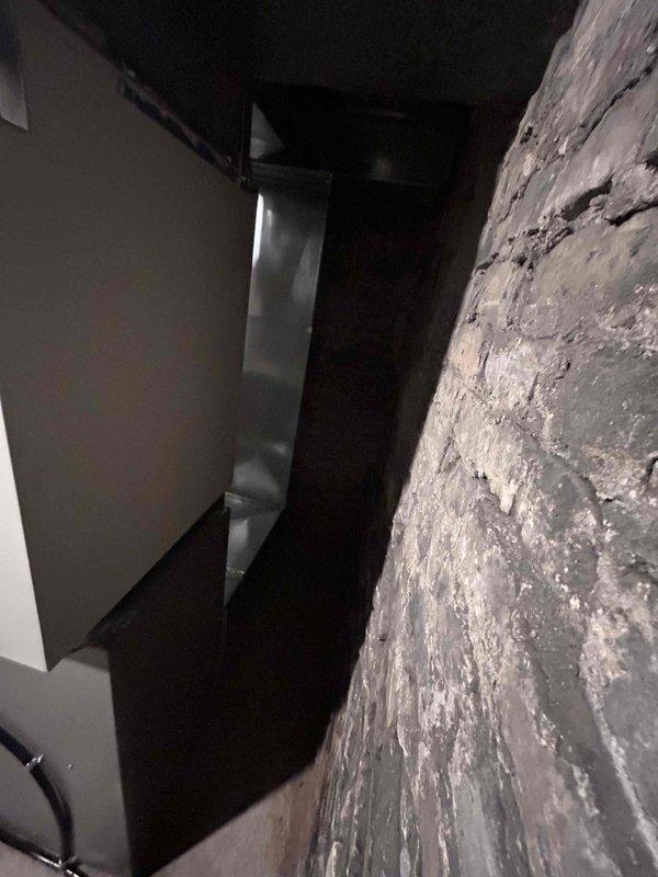 Successfully completed installation of a high-efficiency furnace system in basement utility area, including proper connection of PVC condensate drainage and all necessary electrical components. Unit was securely mounted against concrete block wall with proper clearances maintained, and all connections were tested to verify optimal system performance.