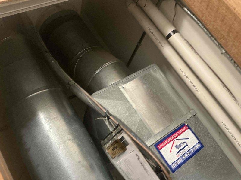 Performed assessment of existing HVAC system showing significant age-related deterioration, including visible corrosion on the housing and worn mechanical components. Recommended full system replacement with new air handler installation, complete with proper ductwork connections and PVC condensate drainage lines. Existing unit's blower assembly and belt system to be replaced with more efficient modern equipment.