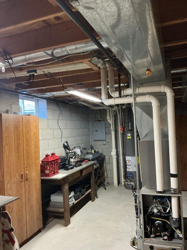Performed routine maintenance inspection on Bryant furnace system in basement mechanical room. Checked all connections on PVC ventilation pipes and verified proper installation of metal ductwork. System is operating within normal parameters with no issues detected.