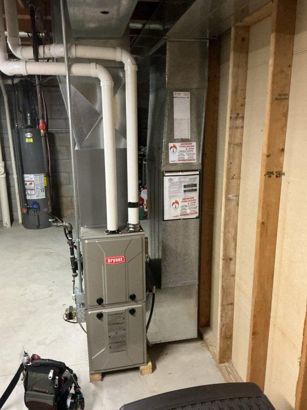 Performed routine maintenance inspection on Bryant furnace system in basement mechanical room. Checked all connections on PVC ventilation pipes and verified proper installation of metal ductwork. System is operating within normal parameters with no issues detected.