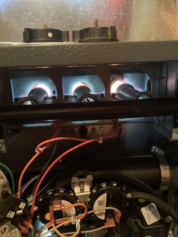 Responded to No Heat call for furnace less than 10 years old. Performed combustion analysis with Testo 310 II showing excellent efficiency at 96.4% with safe CO readings (17 ppm). Inspected burner assembly and verified proper flame pattern across all three burners, confirming system is operating correctly after service.