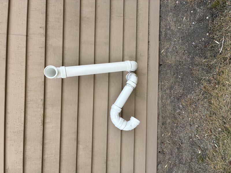 Responded to callback to address drainage issue with HVAC condensate line. Reconfigured PVC piping with proper elbows to create effective drainage path away from foundation. Installed new exterior termination point with appropriate P-trap configuration to ensure proper system ventilation while preventing water intrusion.