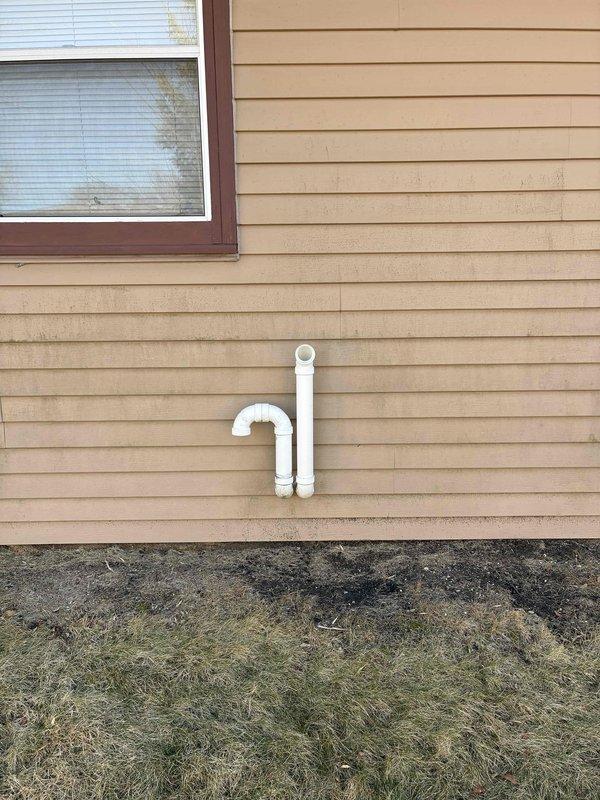 Responded to callback to address drainage issue with HVAC condensate line. Reconfigured PVC piping with proper elbows to create effective drainage path away from foundation. Installed new exterior termination point with appropriate P-trap configuration to ensure proper system ventilation while preventing water intrusion.