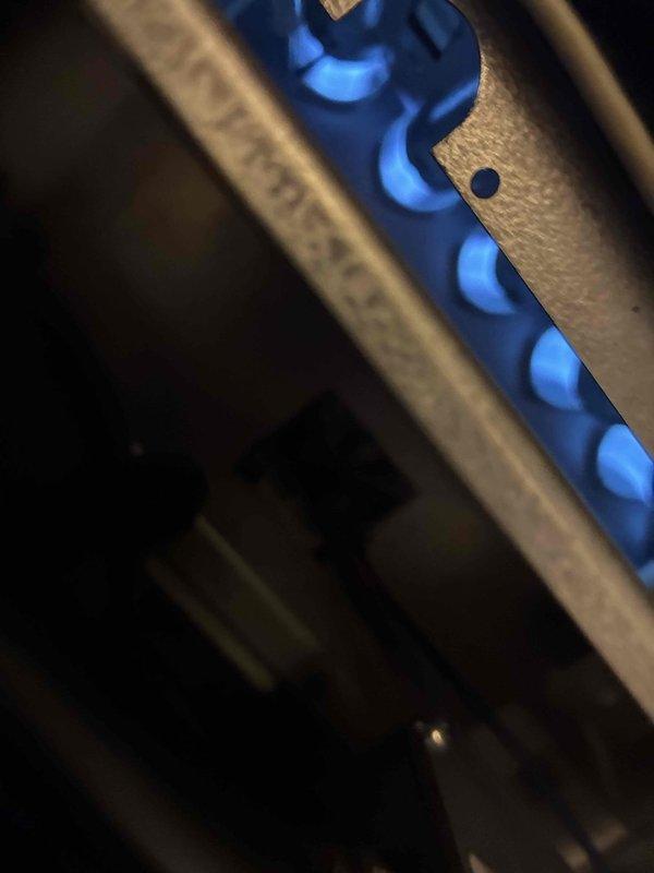 Performed routine maintenance on gas furnace system. Conducted electrical diagnostics with multimeter showing 57.15V reading across control board components. Verified proper flame characteristics with strong blue flame pattern indicating complete combustion and correct gas-air mixture.