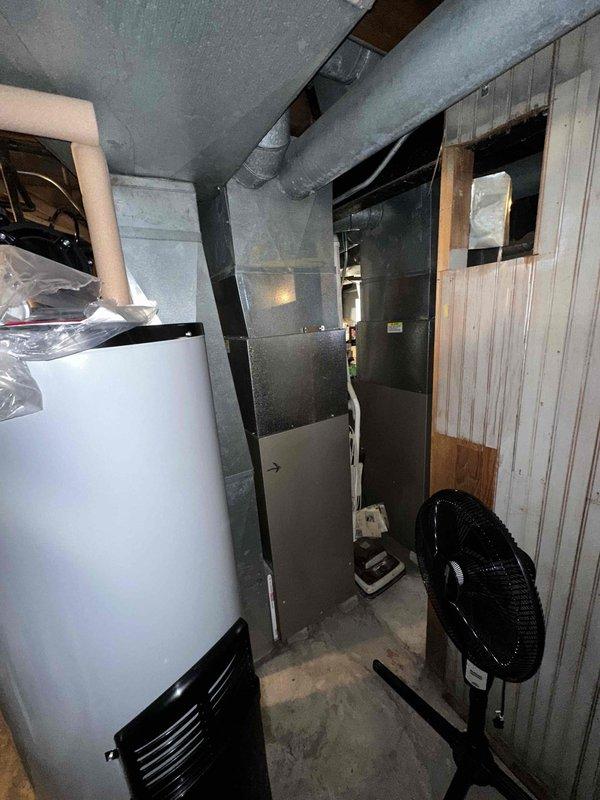 Conducted visual inspection of existing Carrier HVAC system and identified furnace component requiring replacement. Documented current installation configuration including ductwork connections and proximity to water heater. Prepared estimate for replacement of marked furnace component to restore system to proper operating condition.