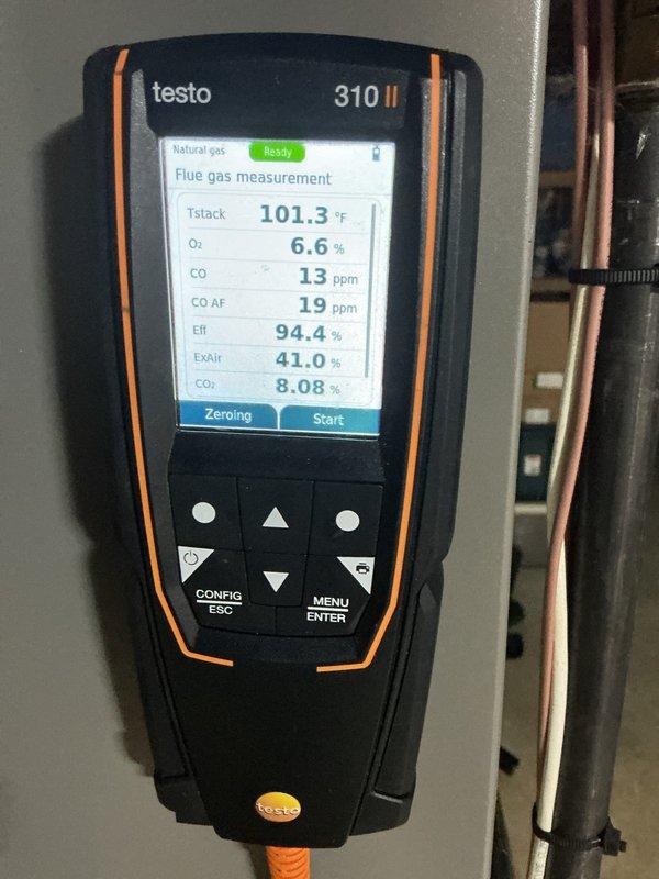 Conducted HVAC maintenance service and performed combustion analysis using Testo 310 II analyzer, measuring stack temperature (101.3°F), O₂ (6.6%), CO (13 ppm), and confirming system efficiency at 94.4%. Inspected plumbing connections for the unit, noting some oxidation on brass/copper fittings that remain functional but should be monitored in future maintenance visits.