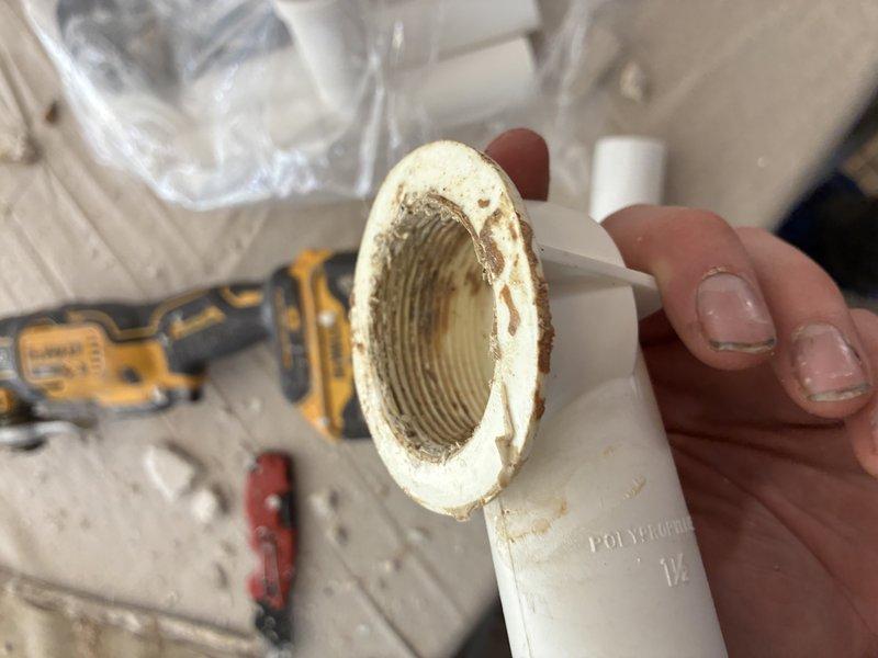 Responded to service call to address drainage issue. Discovered significant mineral buildup and sediment accumulation in the 1½" polyethylene pipe fittings of the residential plumbing system. Removed affected section, cleaned pipe connections, and replaced damaged components to restore proper drainage function.