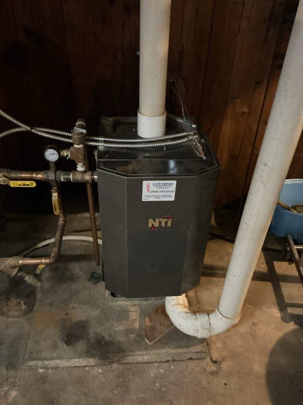 Completed annual maintenance service on NTI water heating system and furnace unit. Inspected internal electrical components, control board connections, and checked all plumbing connections including PVC ventilation and copper supply lines for proper operation. System is functioning within normal parameters after service.