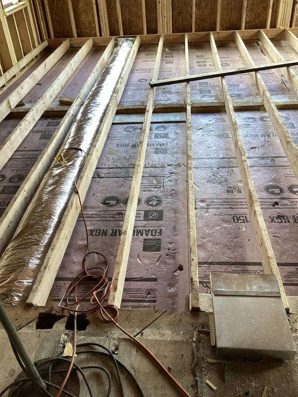 Completed warranty installation of new air handler unit in basement utility area with proper electrical connections. Installed insulation between floor joists with reflective duct wrap and verified all components are properly secured per manufacturer specifications.