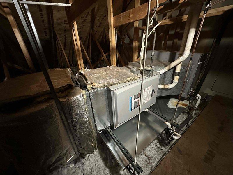 Conducted an Indoor Air Quality (IAQ) assessment of the residential HVAC system, examining the attic-installed air handler with associated ductwork, condensate drainage, and electrical connections. Inspected the ceiling access panel and permanent ladder assembly, noting visible wear and discoloration that could potentially impact indoor air quality.