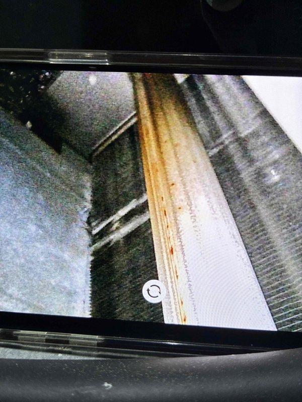 Performed routine inspection of gas furnace with verification of proper flame characteristics and combustion (blue flames observed in burner assembly indicating correct operation). Identified and documented water damage to wooden structural support beam near the furnace/ductwork that requires attention to prevent potential system issues.