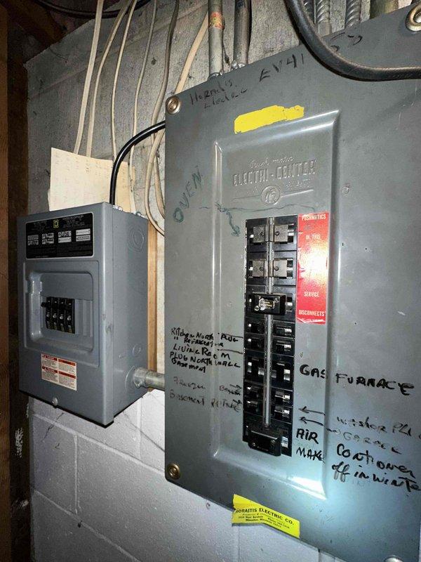 Conducted assessment of aging HVAC system with deteriorating equipment labels and compromised wiring connections. Documented electrical panel configuration showing multiple circuit breakers with handwritten system identifiers including "GAS FURNACE" and "AIR" notations. Recommended complete system replacement due to visible wear and potential electrical safety concerns.