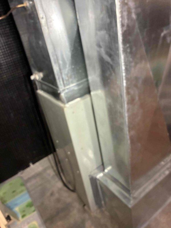 Responded to no-heat service call on aging HVAC system (10+ years). Inspected ductwork connections and identified significant dust accumulation in the main unit. Removed and replaced damaged blower motor assembly (blue cylindrical component) and rewired electrical connections to restore proper heating function.