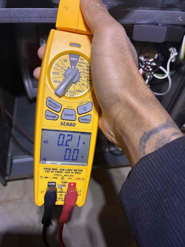 Diagnosed no heat issue in system less than 10 years old. Testing with Fieldpiece SC680 clamp meter revealed low amperage reading of 0.21A and 0.0V, indicating electrical failure. Verified Honeywell Home ProSeries thermostat was functioning correctly with proper heat call signal at 72°F. Repaired electrical connection to restore proper voltage to heating components.