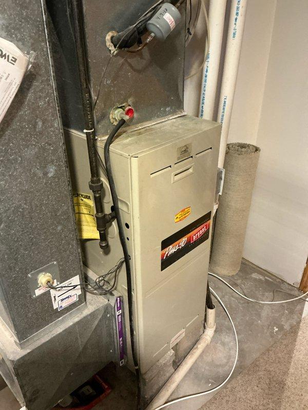 Conducted comprehensive assessment of existing HVAC system consisting of an aging Plus Ultra furnace and Payne outdoor condensing unit. System shows significant wear with snow accumulation on outdoor unit and dust buildup on indoor components, indicating replacement is recommended to improve efficiency and reliability before complete failure occurs.