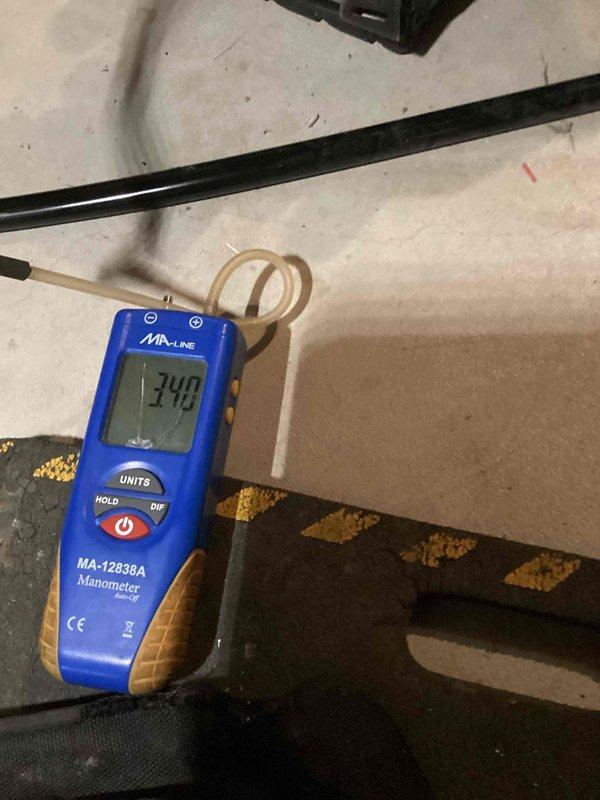 Completed installation of a complete HVAC system in basement utility area, including furnace unit with connected ductwork, electrical controls, and condensate pump. System was pressure tested with digital manometer (MA-12838A), confirming proper system pressure at 3.40 units, ensuring optimal operation of the newly installed equipment.