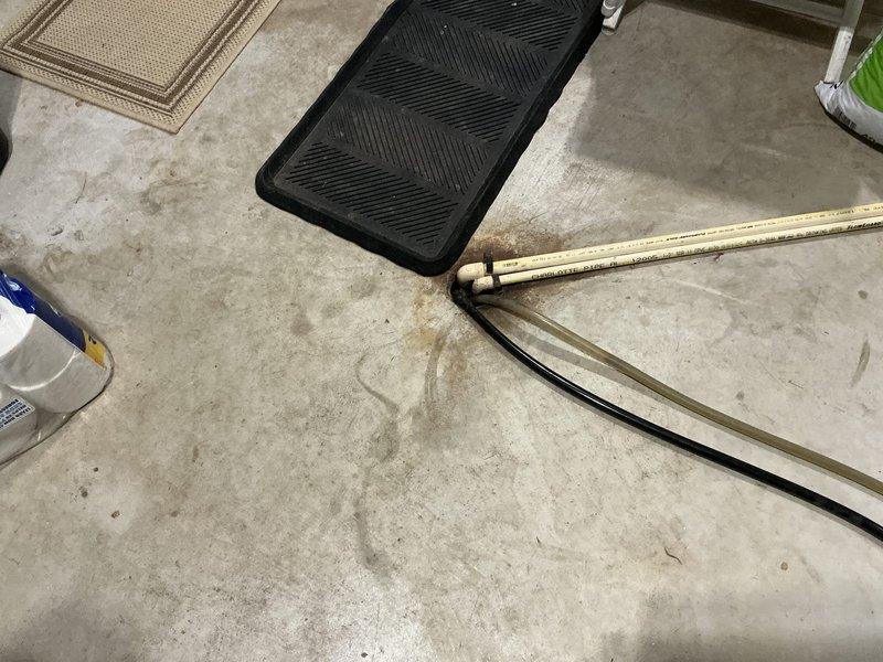 Conducted site assessment in basement area for HVAC replacement, documenting existing ductwork configuration and available installation space. Measured floor area using folding ruler to determine appropriate unit sizing requirements for the new system.