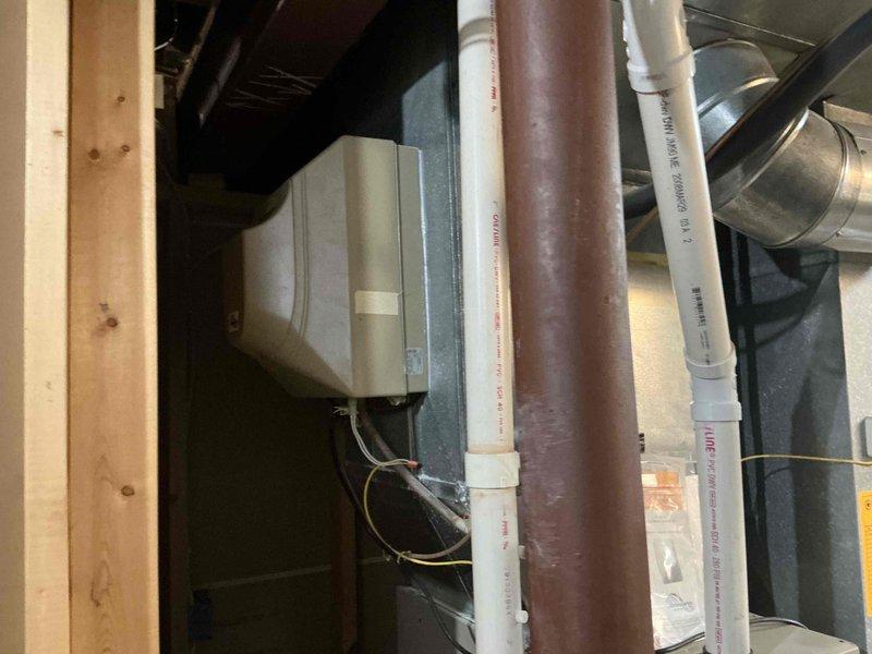 Conducted comprehensive assessment of aging Ducane HVAC system installed in residential attic space. Unit shows significant weathering with visible water damage and deterioration. Recommended full system replacement due to age-related wear, potential efficiency issues, and to ensure compliance with current specifications as indicated on manufacturer labels.