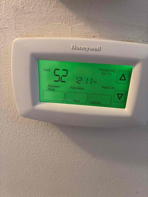 Responded to no-heat call for 10+ year old furnace system. Upon inspection, found significant dust accumulation on internal components requiring thorough cleaning. Thermostat was functioning properly in heat mode but showing 52°F indoor temperature with "Heat On" status, indicating furnace failure to produce adequate heat. Serviced unit by cleaning components, replacing worn igniter, and verifying proper operation with the Honeywell digital thermostat.