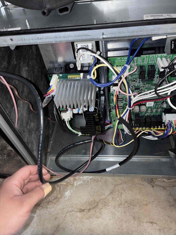 Performed diagnostic inspection of HVAC system circuit board and control components. Examined PCB with connected wiring harness for functionality and verified proper installation of temperature sensor module on refrigerant coils. All components confirmed to be in normal operating condition with no visible damage or abnormalities detected.