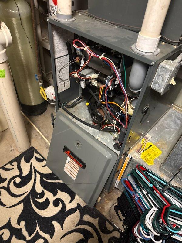 Performed diagnostic inspection on aging furnace showing no heat operation. Opened furnace cabinet to examine control board and wiring connections, noting significant wear on components typical of 10+ year old system. Utilized Testo 310 II flue gas analyzer to test combustion efficiency and safety parameters, confirming normal oxygen levels (21.0%) and zero carbon monoxide emissions while verifying stack temperature at 119.1°F.