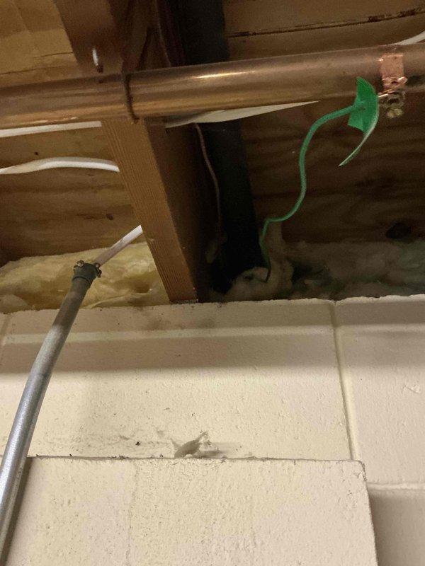 Conducted inspection of HVAC system components, documenting copper refrigerant lines, drainage PVC piping with proper elbow joints, and galvanized metal ductwork. Identified normal dust accumulation on metal surfaces requiring standard maintenance, and verified all connection points and fasteners are secure for system replacement estimate.