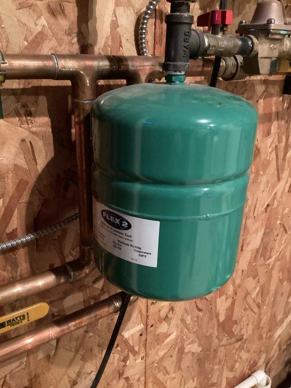 Installed new Adams boiler system with digital interface for improved climate control functionality. Connected copper supply/return lines and installed FLEX expansion tank with appropriate valves and fittings. System tested and verified operational with proper water pressure maintained throughout heating circuit.